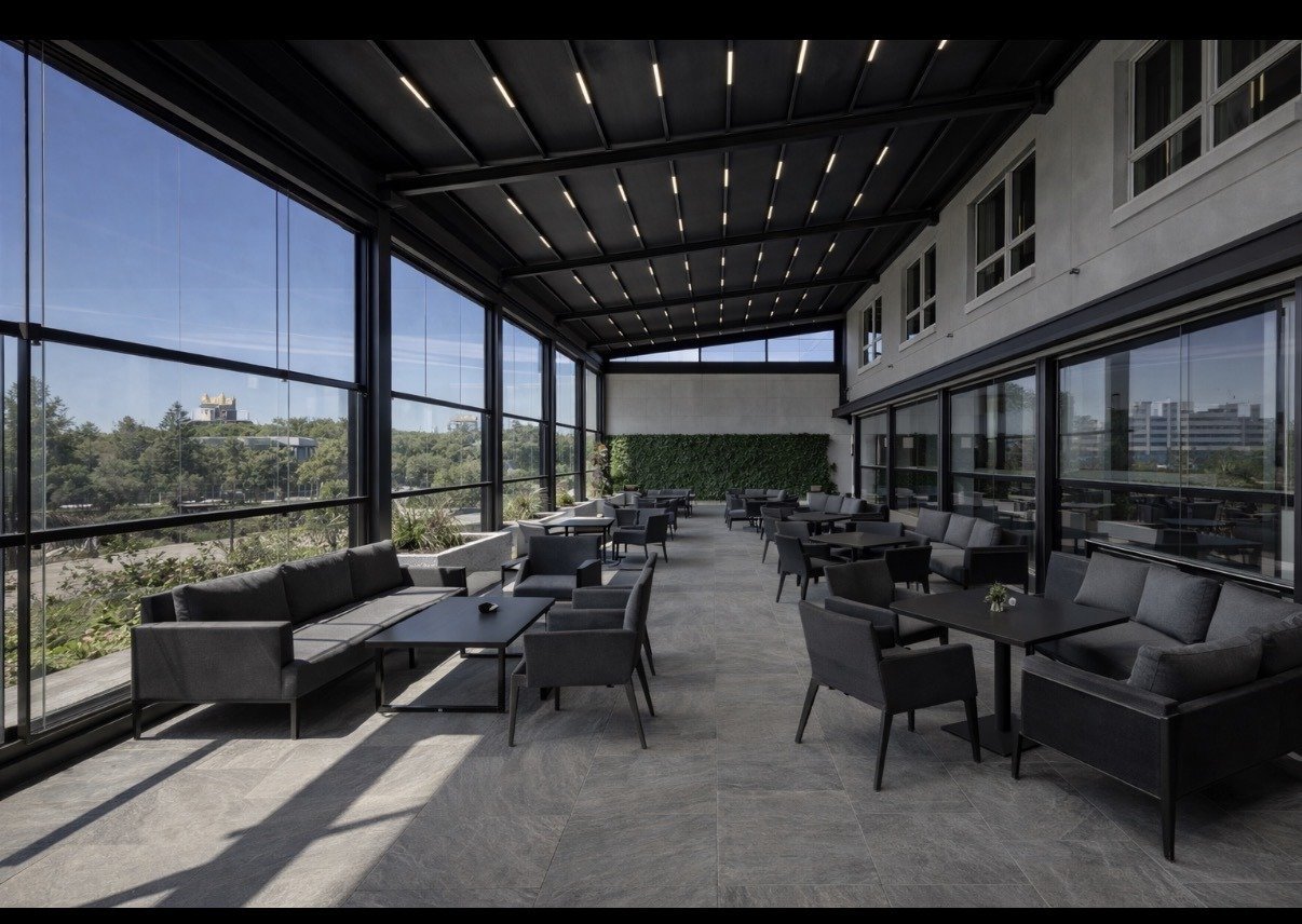 Sliding glass patio enclosure under a pergola
